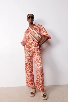 Stella Forest MORGANA CORAL PRINTED SATIN EFFECT FLARED TROUSERS